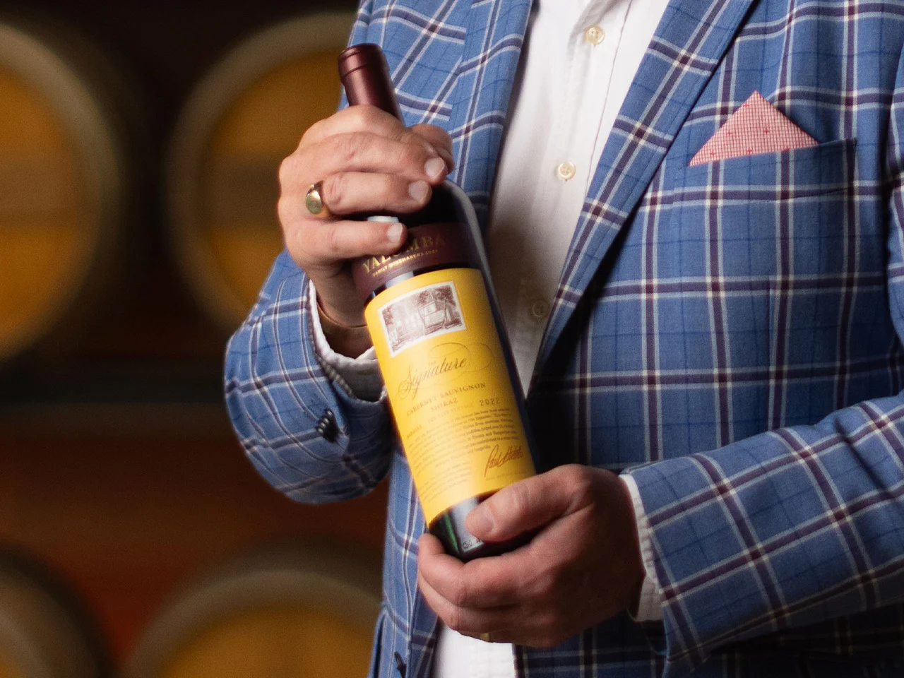 Paul Midolo, holds a bottle of the 2022 Signature with a big smile on his face