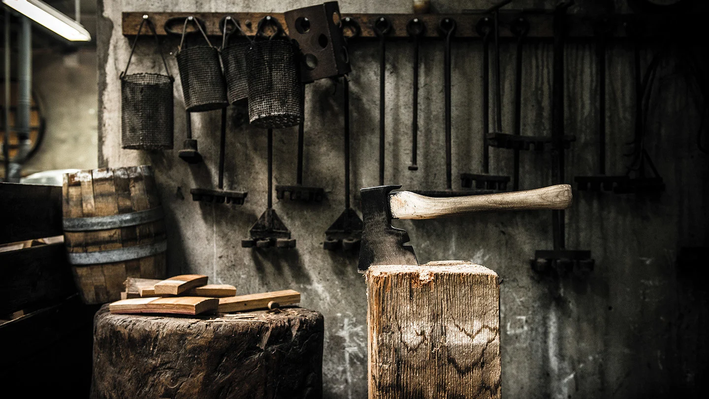 Traditional cooperage workshop with axe, wooden stump and barrel-making tools