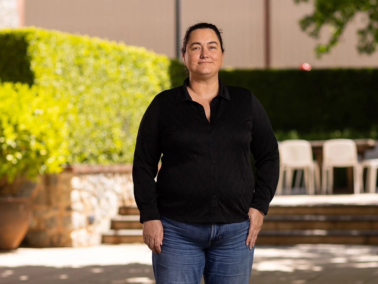 Heather Fraser, Senior Winemaker and Laboratory at Yalumba, standing in black shirt outdoors at the winery