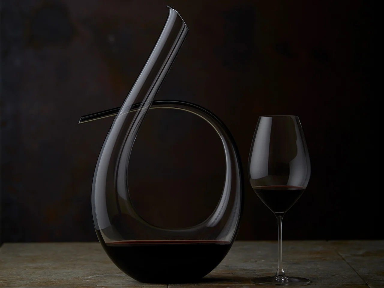 A glass of The Tri-Centenary sitting next to it's decanter
