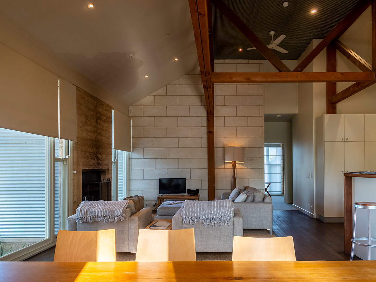 A look inside the Menzies retreat lounge area, showing couches and a fireplace in front of a light brick wall