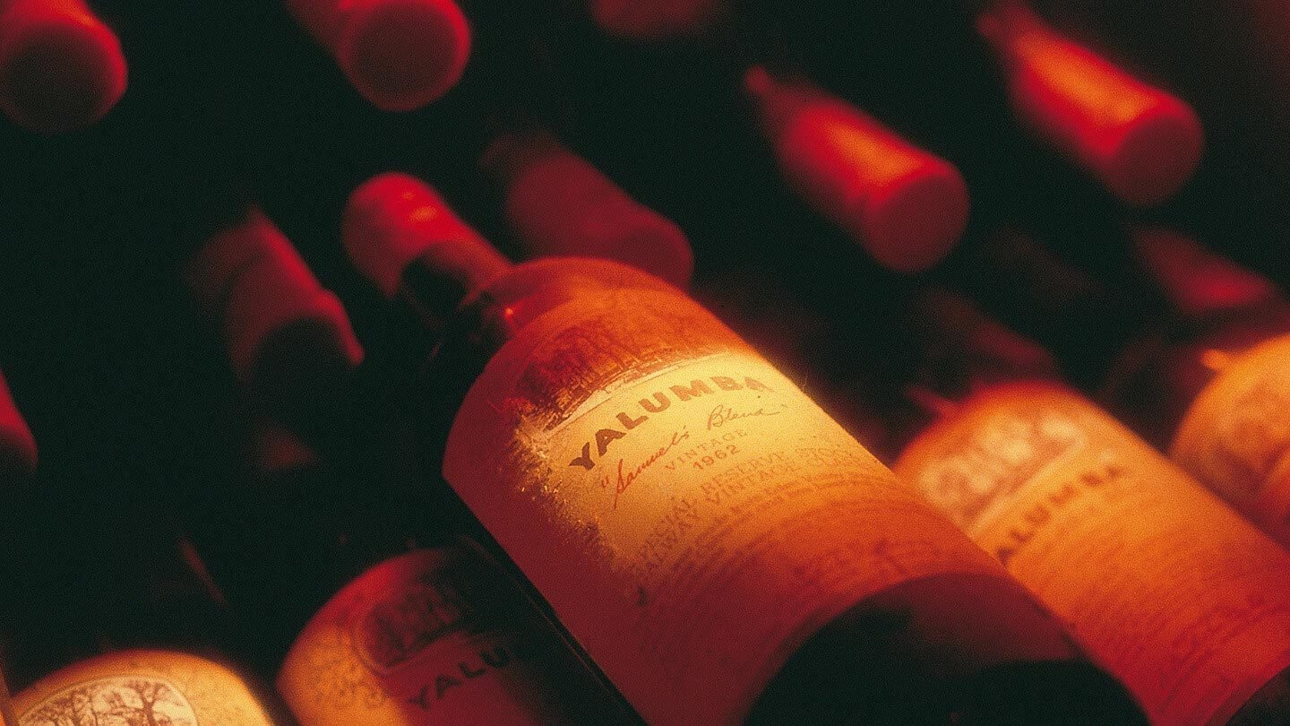 A close up image of an aged and dusty bottle of one of Yalumbas red wines.