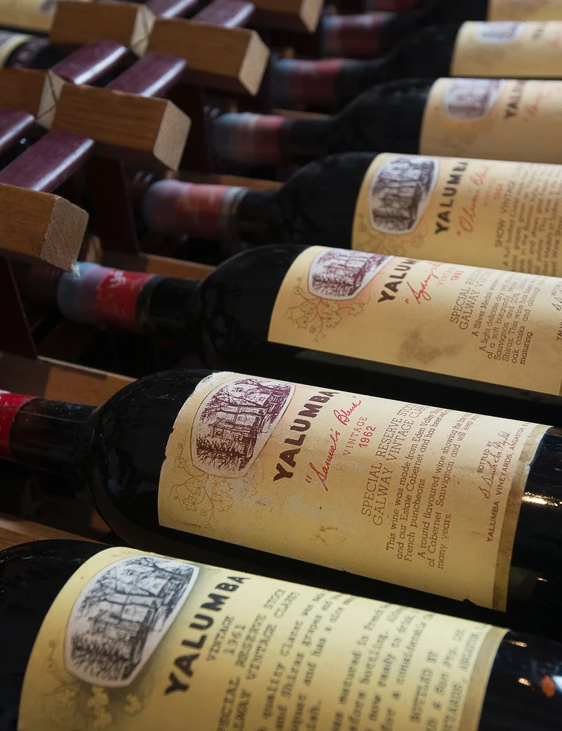 A close up image
                of multiple bottles of The Signature sitting in long term storage, dating back to
                1962.