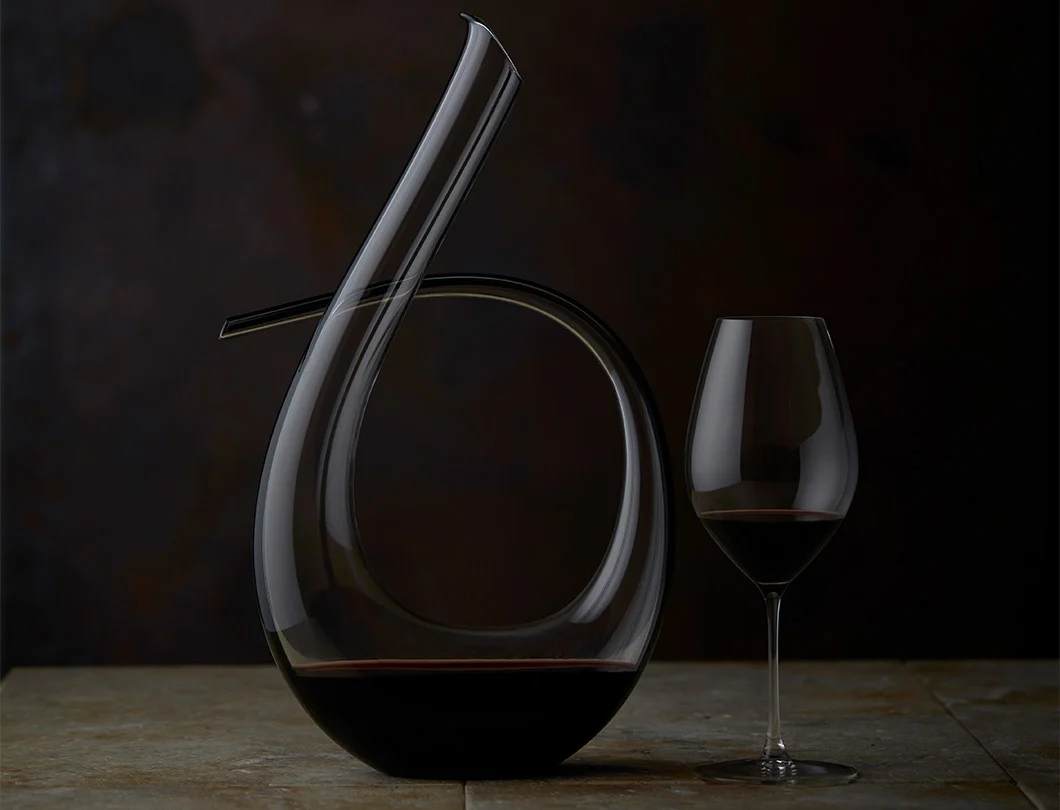 A glass of The Caley sitting next to it's decanter