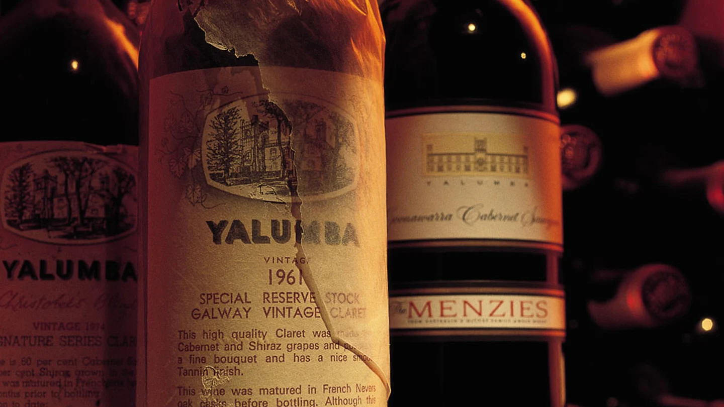 A close up image of an aged and dusty bottle of one of Yalumbas red wines.