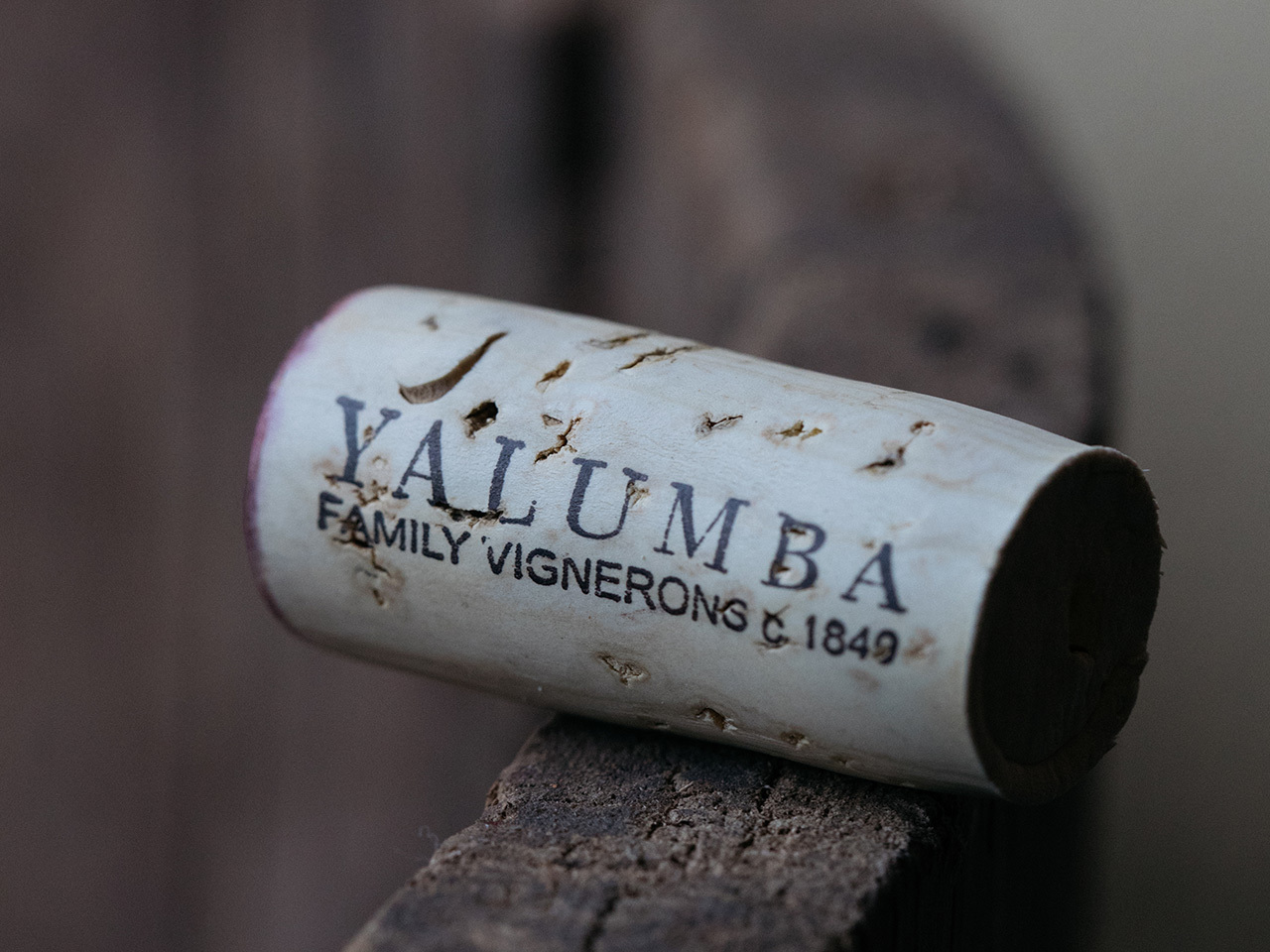 A close up image of a Yalumba cork sitting on the edge of a barrel