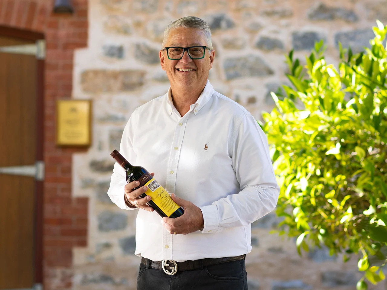 Paul Midolo, the 2022 signator holding a bottle of Yalumba Signature 2022