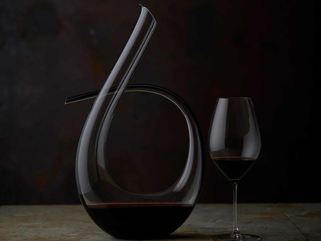 A professionally photographed image of a beautiful Decanter and a glass containing red wine.