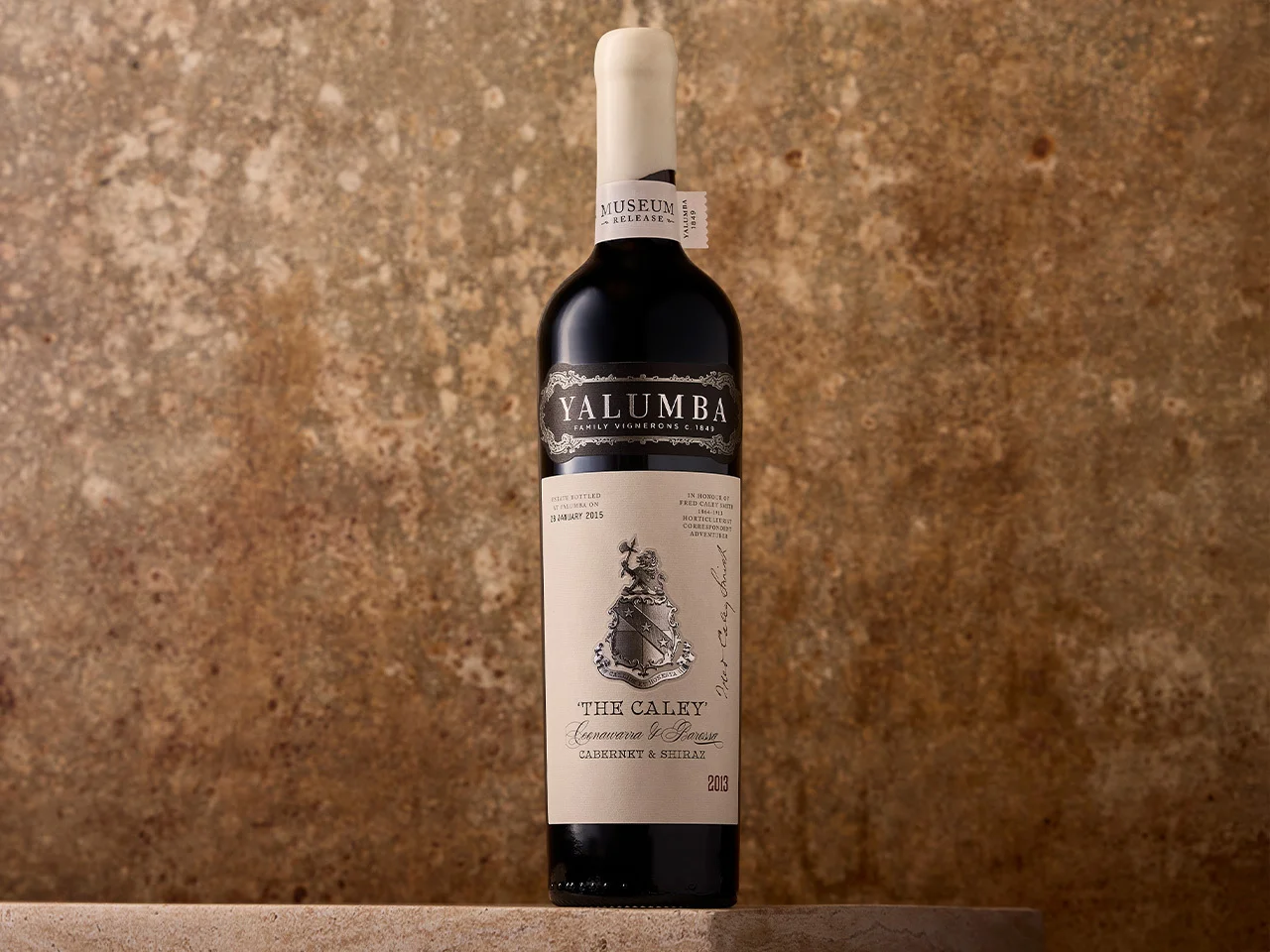 The Caley Cabernet & Shiraz bottle against textured rustic background