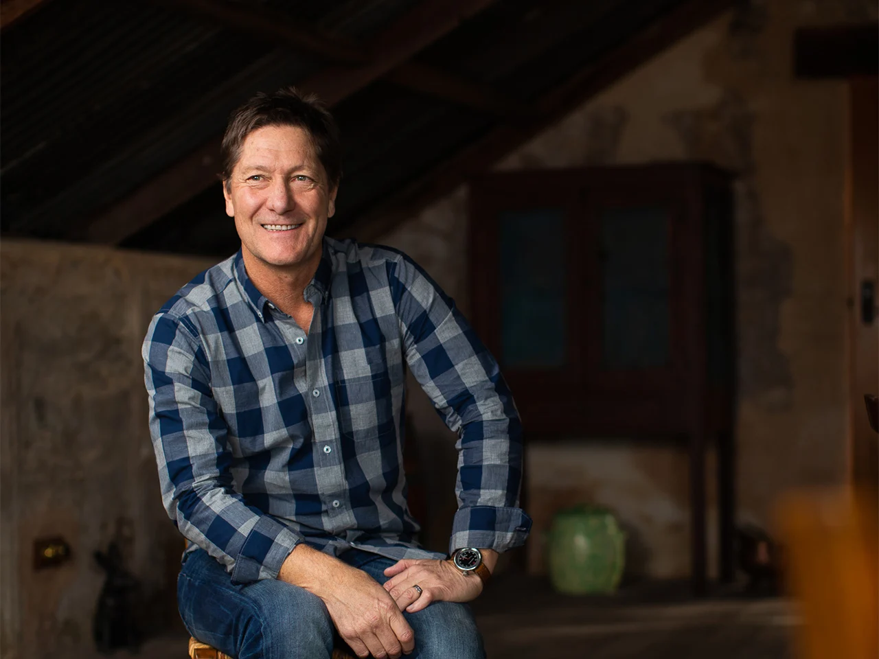 Kevin Glastonbury, Senior Winemaker at Yalumba, smiling in checkered shirt in the winery