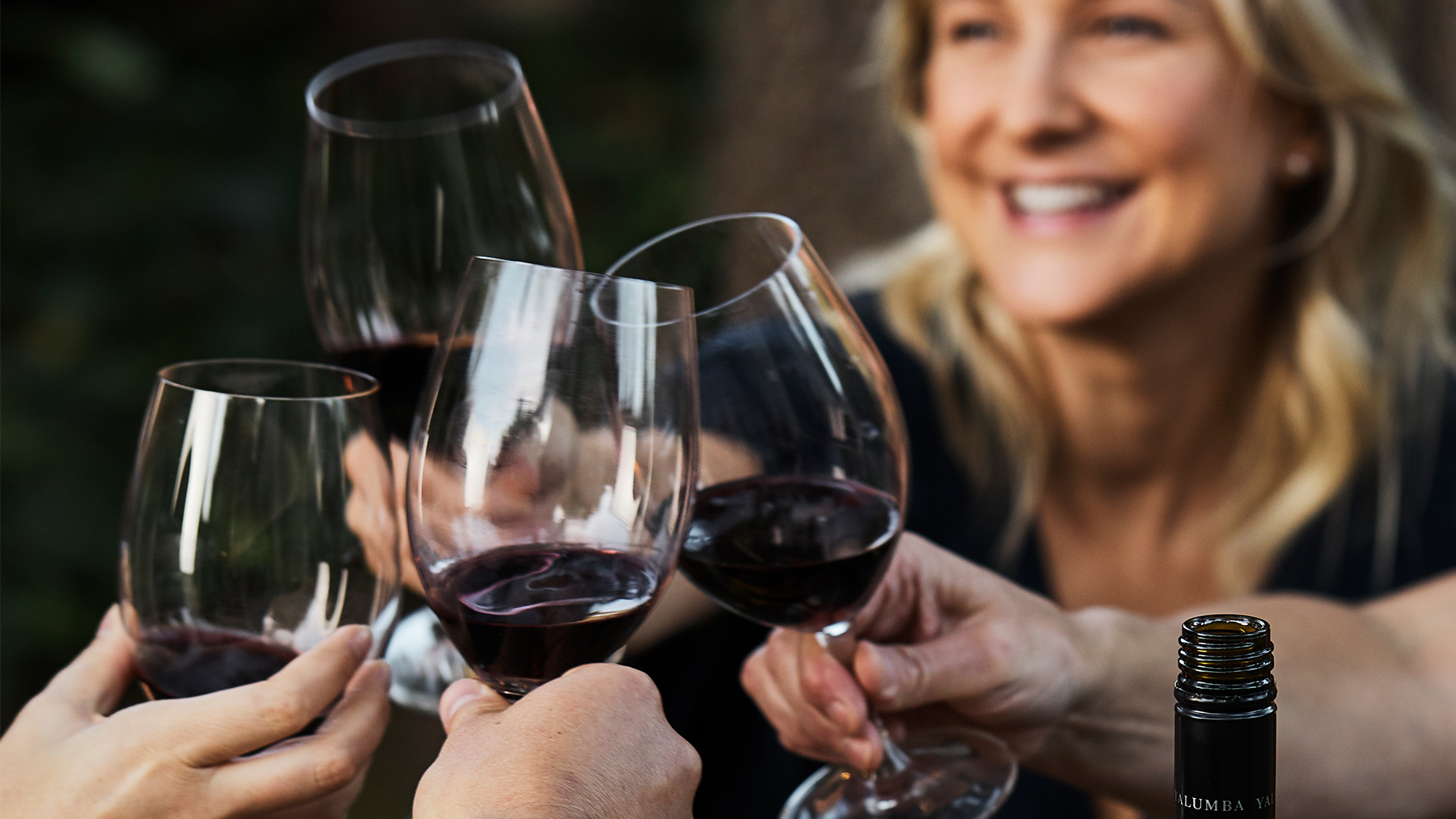 Some people embrace in a "cheers" with their red Yalumba wine
