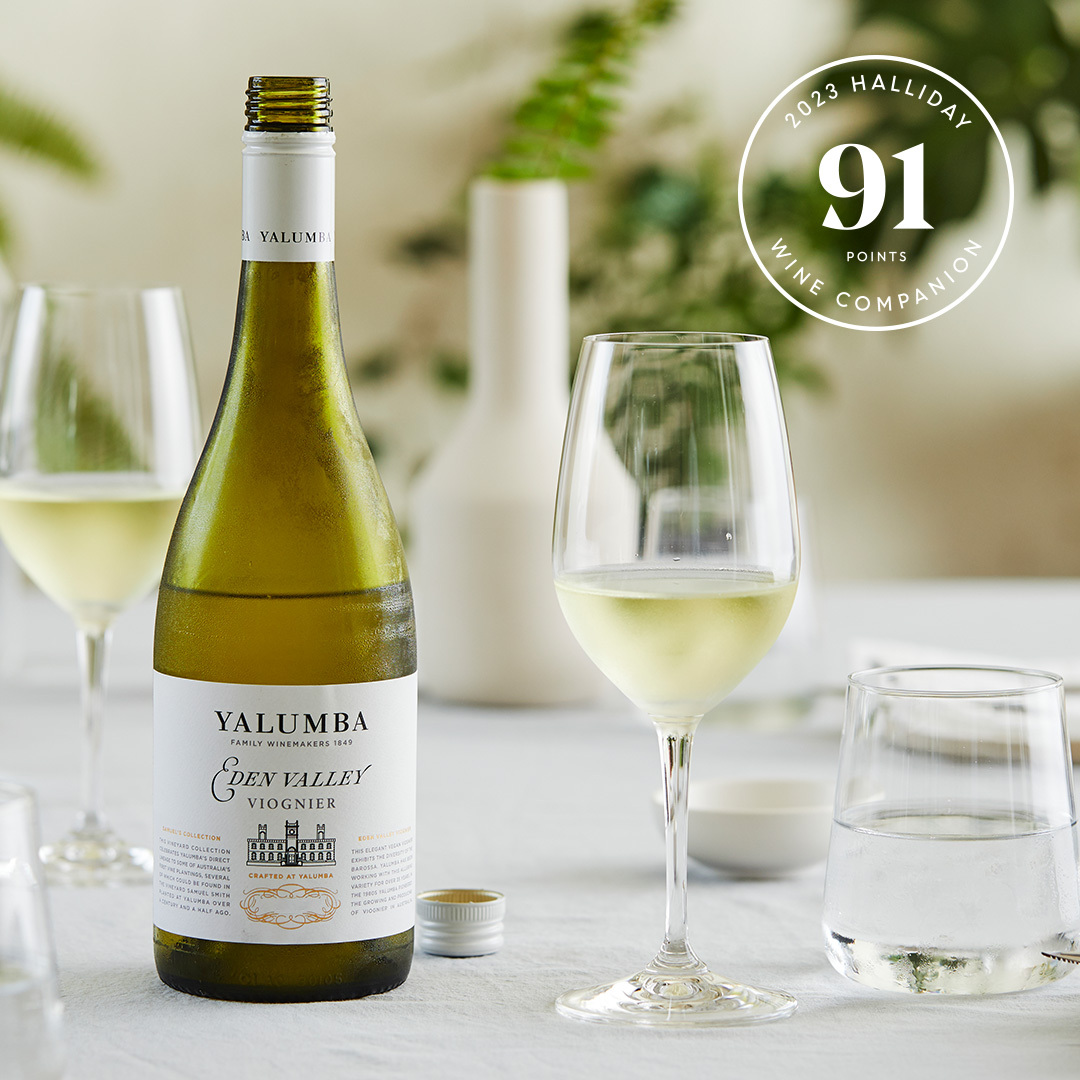 A crisp glass of Eden Valley Viognier sitting next to it's open bottle.