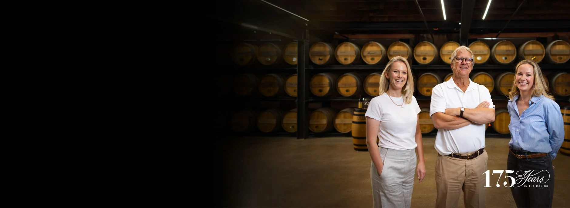 Three members of the Hill-Smith family, posing for a photo inside the barrel cellar