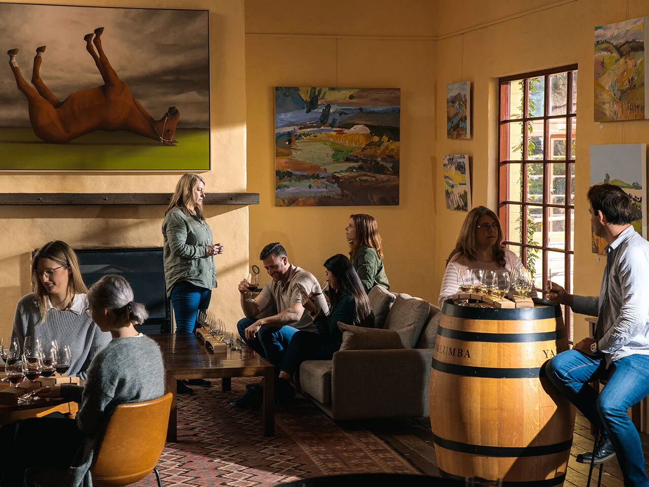 Guests enjoying a seated wine tasting experience in the Yalumba Wine Room with artwork on walls