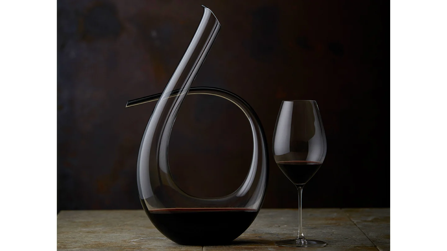 A glass of The Menzies sitting next to it's decanter