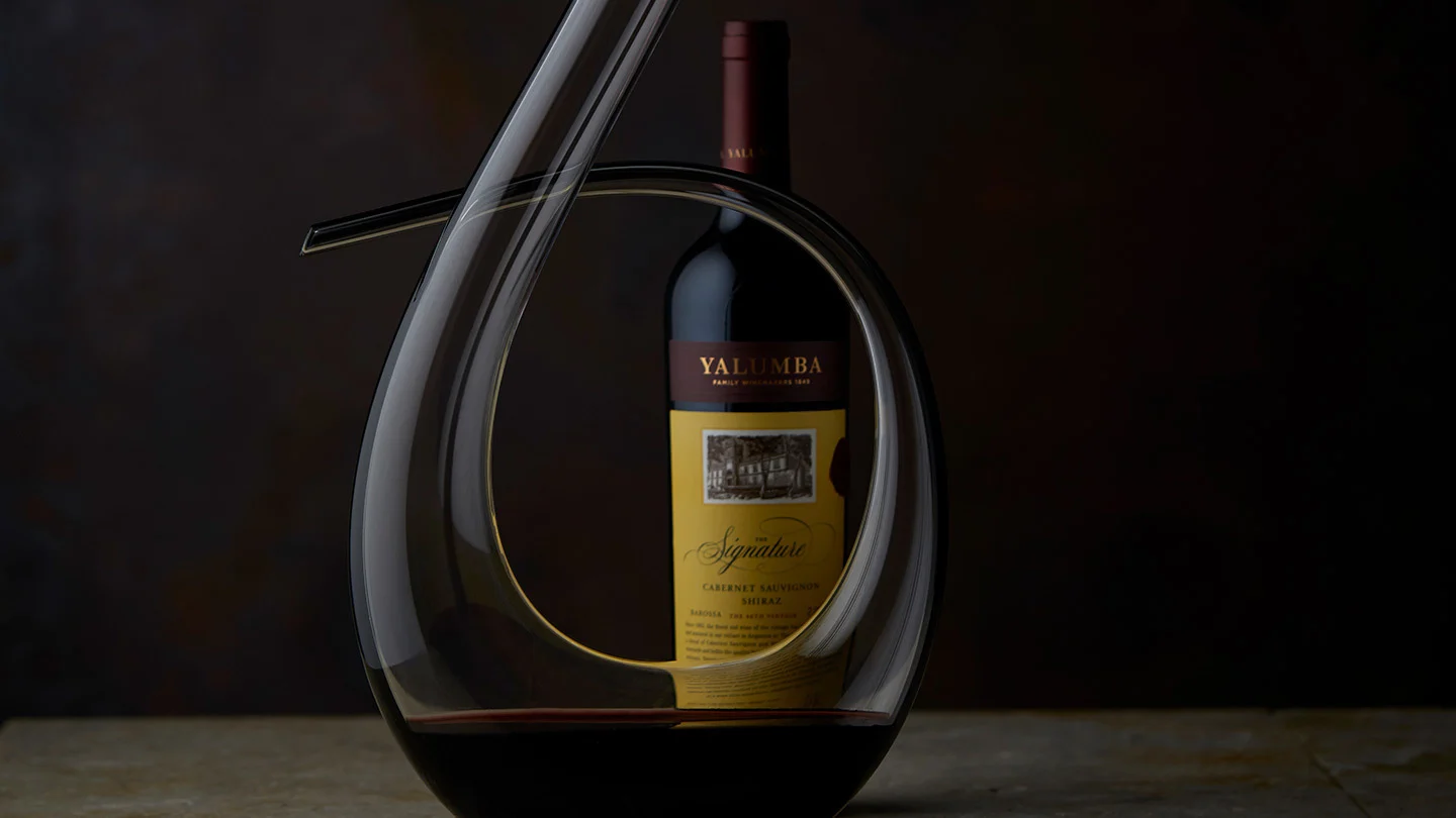 A bottle of The Signature sitting next to it's decanter