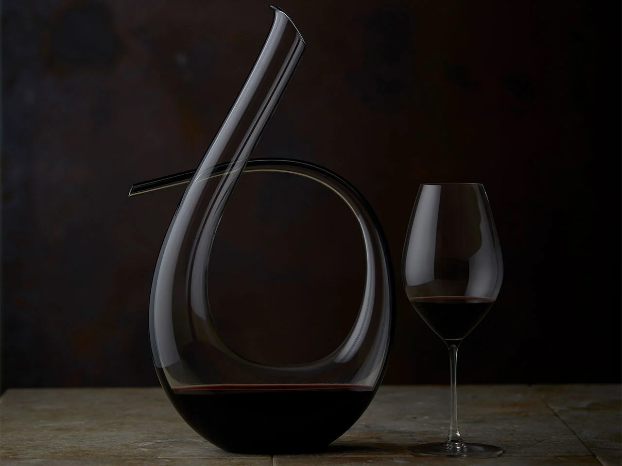 A glass of The Octavius sitting next to it's decanter