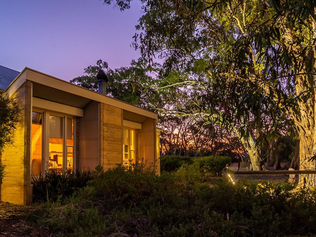 Menzies Wine Room exterior at sunset with illuminated entrance and native garden