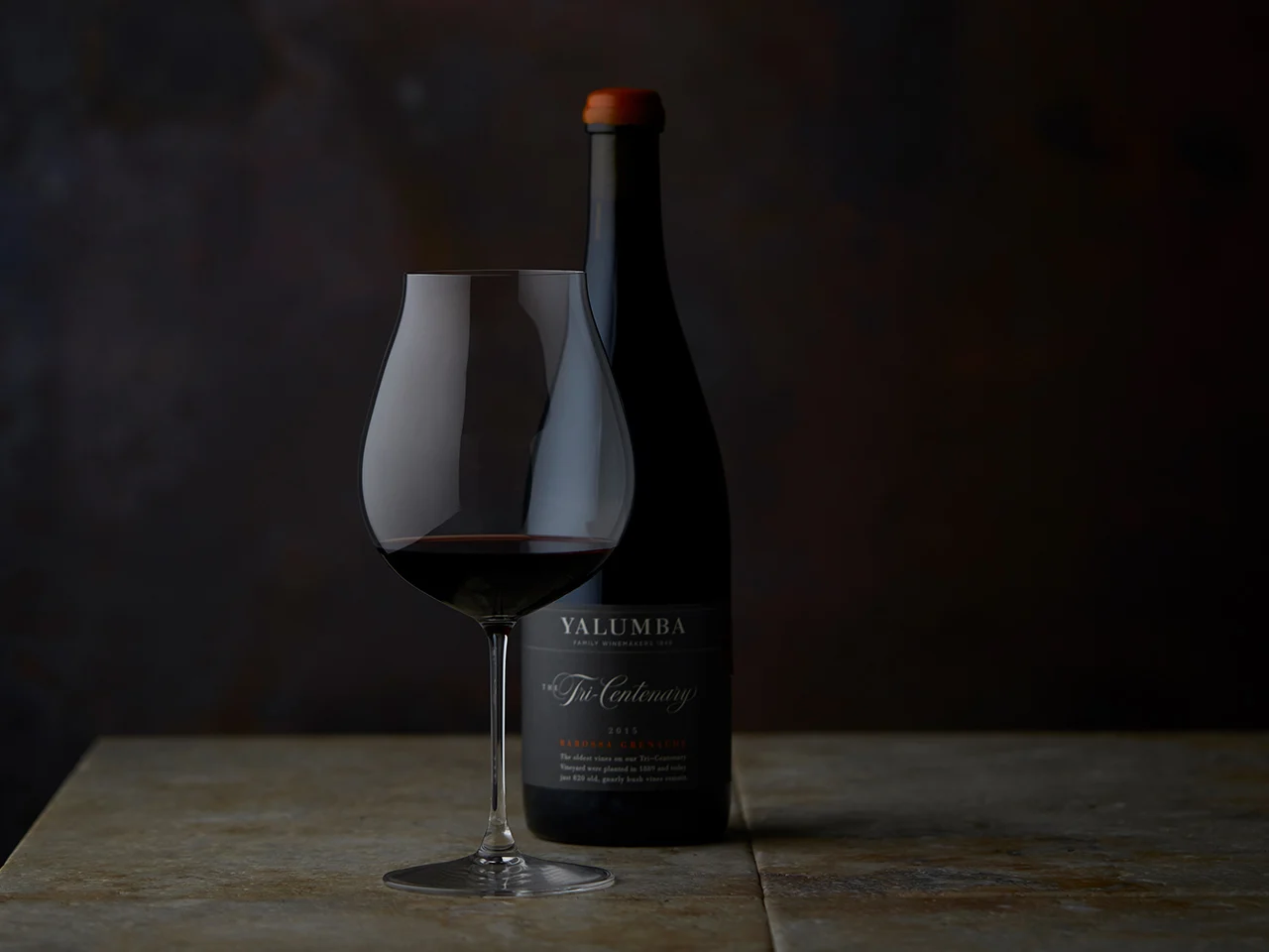 A glass of The Tri-Centenary sitting in front of the bottle